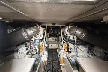 Slide: The Image of Engine room of a 1996 Buddy Davis 67 yacht, showcasing dual engines and mechanical components. - 18