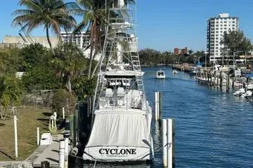 Slide: The Image of 1996 Buddy Davis 67 yacht docked in a sunny marina with palm trees. - 2