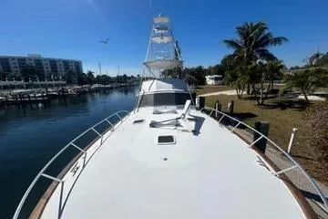 Slide: The Image of 1996 Buddy Davis 67 yacht docked in sunny marina with palm trees. - 4