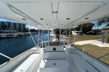 Slide: The Image of 1996 Buddy Davis 67 yacht, spacious deck view, docked near waterfront properties. - 5