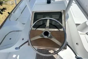 Slide: The Image of Steering wheel of a 1996 Buddy Davis 67 yacht, showcasing classic design and controls. - 7
