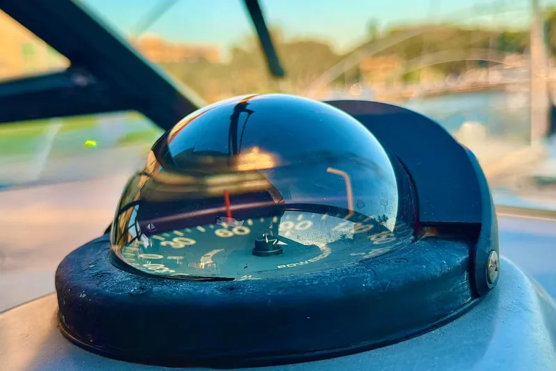 Slide: The Image of Close-up of a compass on a 2000 Tiara 37 Open boat, with blurred background. - 11