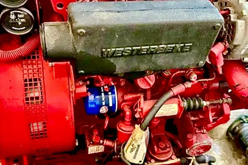 Slide: The Image of Westerbeke engine in a 2000 Tiara 37 Open boat, featuring red components. - 112