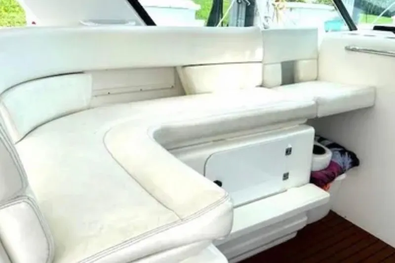 Slide: The Image of Interior seating of 2000 Tiara 37 Open yacht, featuring white cushioned benches. - 18