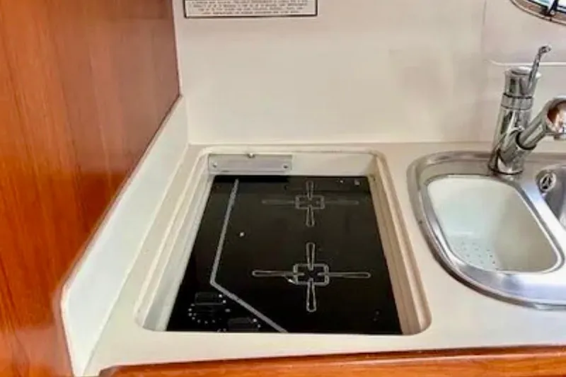 Slide: The Image of Kitchen area in 2000 Tiara 37 Open yacht with stove and sink. - 25