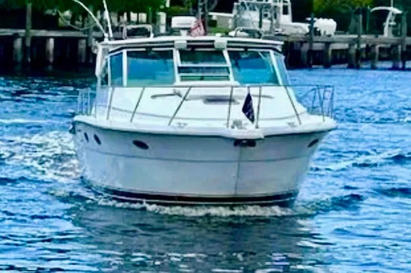 Slide: The Image of 2000 Tiara 37 Open yacht cruising on a calm waterway. - 3