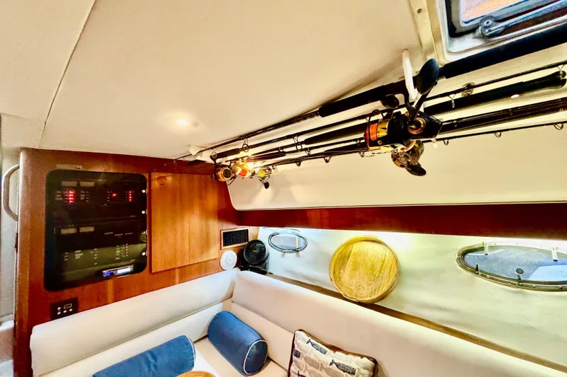 Slide: The Image of Interior of 2000 Tiara 37 Open yacht with fishing rods and cozy seating area. - 35