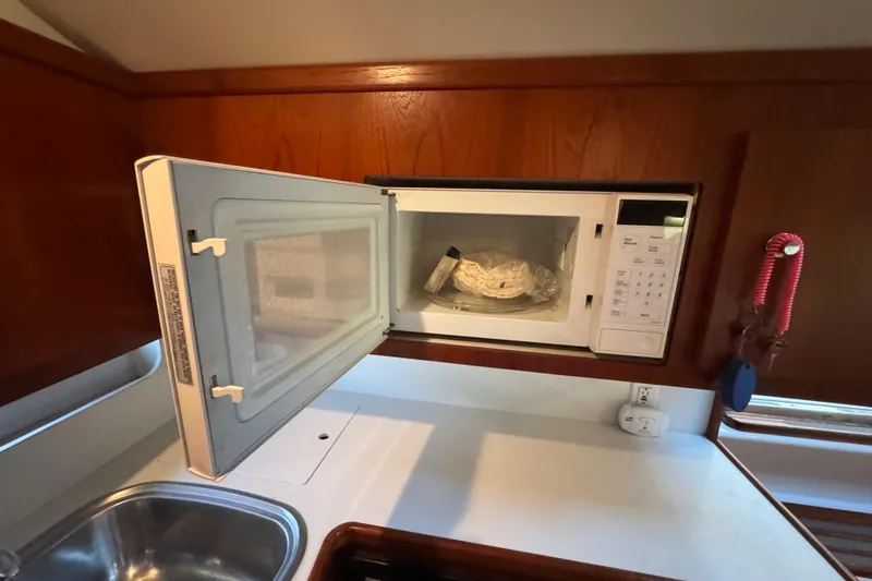Slide: The Image of Microwave in Tiara 37 Open yacht kitchen, 2000 model, with wooden cabinetry. - 41