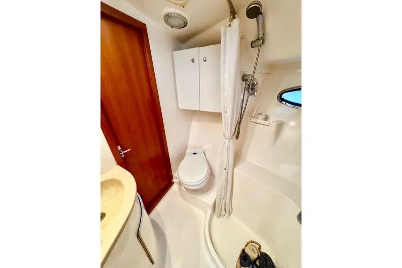 Slide: The Image of Bathroom in 2000 Tiara 37 Open yacht with shower, toilet, and sink. - 51