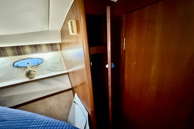 Slide: The Image of Interior of 2000 Tiara 37 Open yacht with wooden cabinetry and porthole. - 54