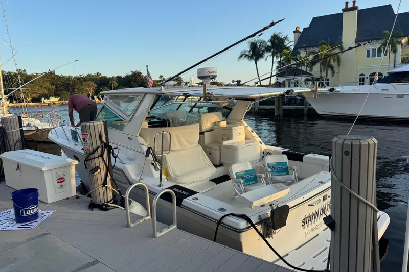 Slide: The Image of 2000 Tiara 37 Open yacht docked at marina with fishing gear and scenic background. - 72