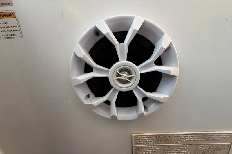 Slide: The Image of White speaker on a 2000 Tiara 37 Open boat, with warning label nearby. - 81