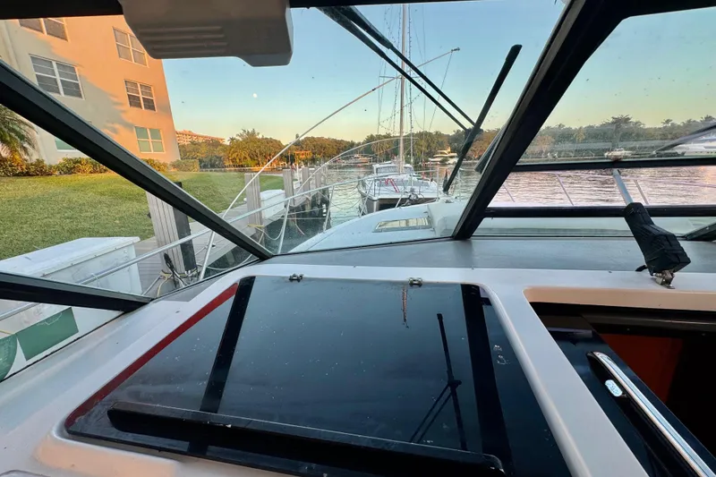 Slide: The Image of View from the helm of a 2000 Tiara 37 Open yacht docked by a waterfront. - 83