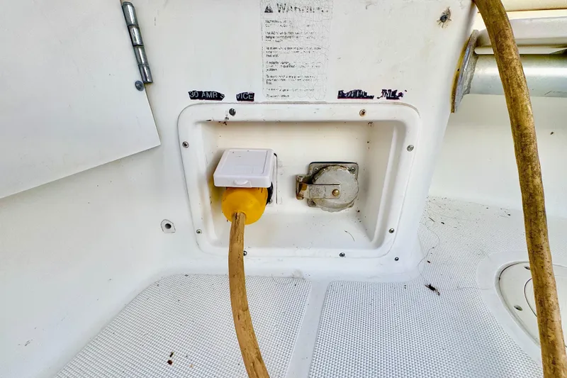 Slide: The Image of Electrical outlet on 2000 Tiara 37 Open boat with yellow power cord connected. - 90