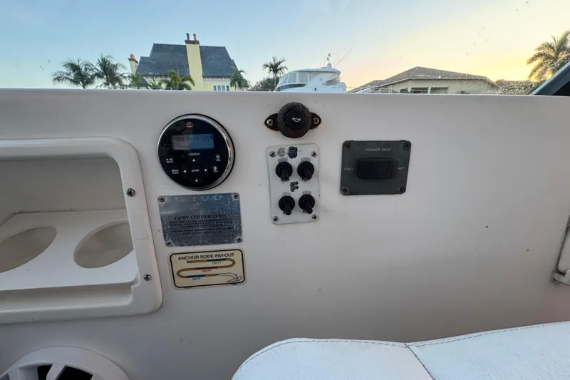 Slide: The Image of Control panel of a 2000 Tiara 37 Open yacht with various switches and gauges. - 92