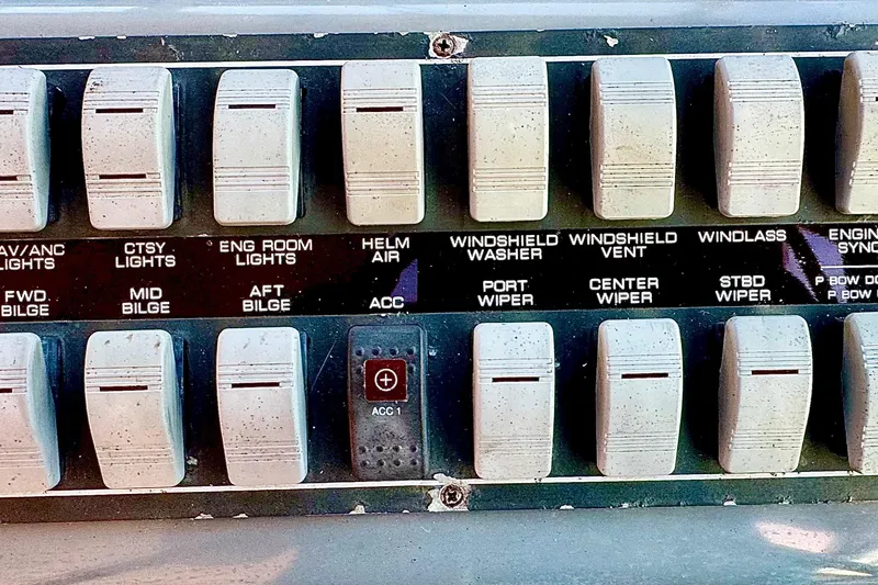 Slide: The Image of Control panel switches on a 2000 Tiara 37 Open boat dashboard. - 95