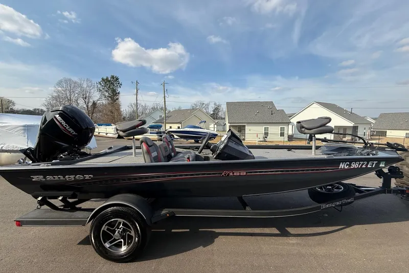 Slide: The Image of 2021 Ranger RT188 boat with Mercury engine, parked on a trailer in a residential area. - 3