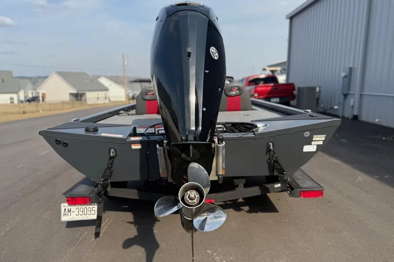 Slide: The Image of 2021 Ranger RT188 boat with outboard motor on trailer, parked near buildings. - 4