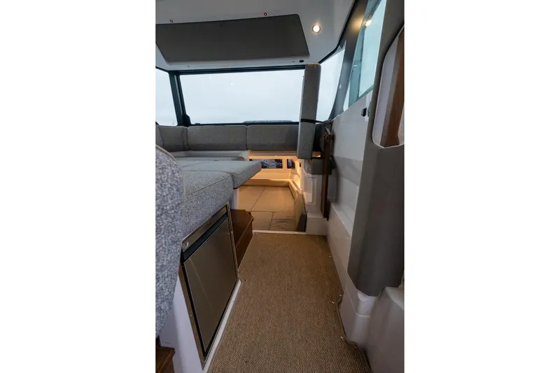 Slide: The Image of Interior of 2027 Axopar 38 Cross Cabin, featuring modern seating and sleek design. - 14