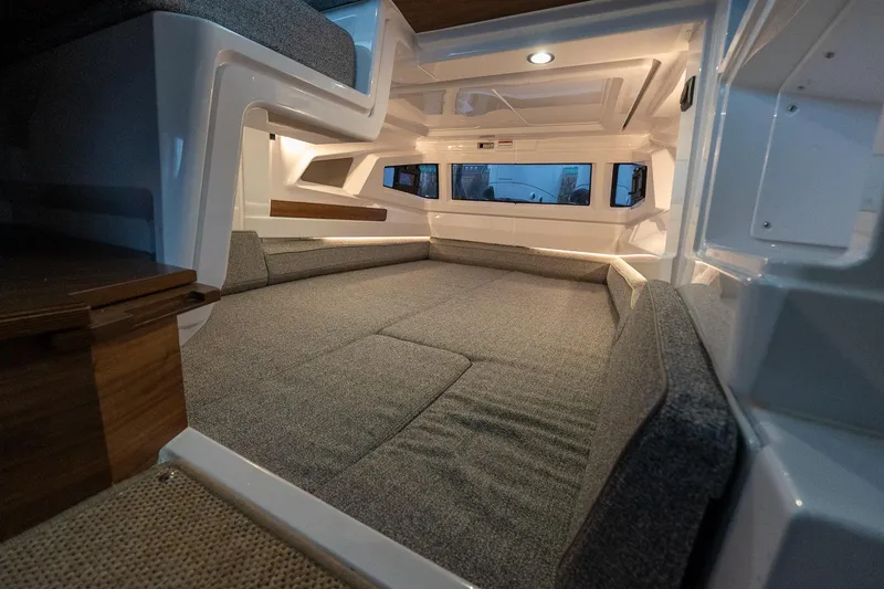 Slide: The Image of 2027 Axopar 38 Cross Cabin interior with cozy sleeping area and modern design. - 16