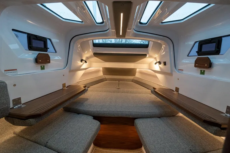 Slide: The Image of Luxurious interior of 2027 Axopar 38 Cross Cabin with modern seating and ambient lighting. - 32