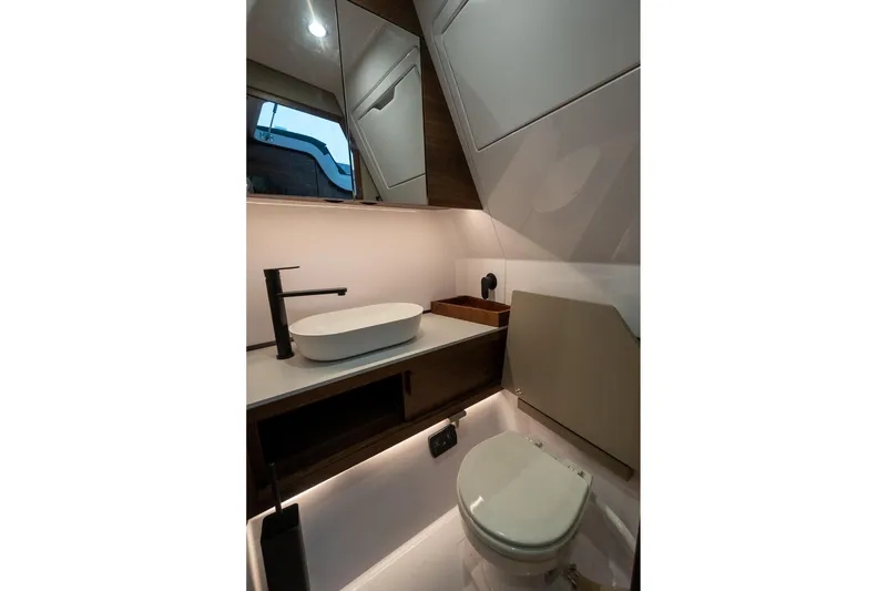 Slide: The Image of Modern bathroom in 2027 Axopar 38 Cross Cabin with sleek fixtures and minimalist design. - 38