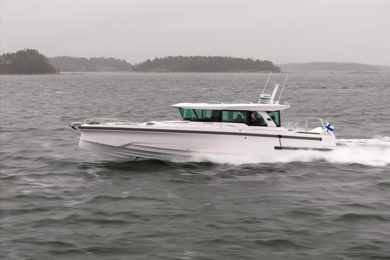 Slide: The Image of 2027 Axopar 38 Cross Cabin boat cruising on a cloudy day. - 4