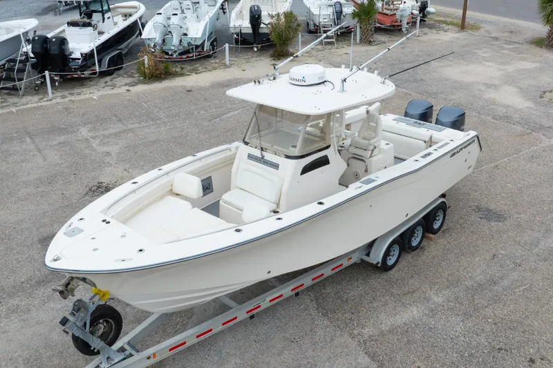 Slide: The Image of 2017 Grady-White Canyon 306 boat on trailer, parked in a marina lot. - 1