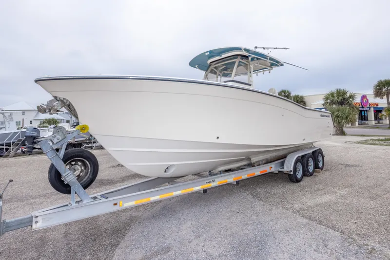 Slide: The Image of 2017 Grady-White Canyon 306 boat on trailer, parked outdoors. - 11