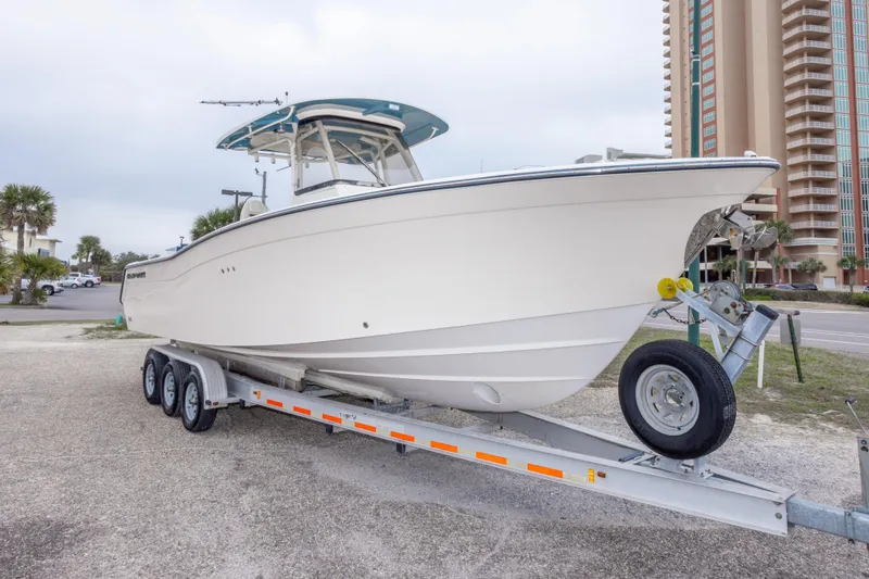 Slide: The Image of 2017 Grady-White Canyon 306 boat on trailer near high-rise buildings. - 12
