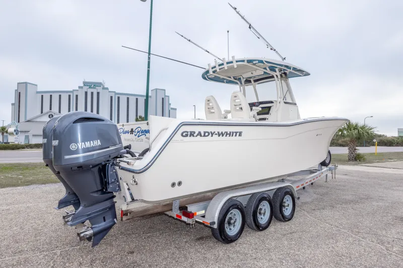 Slide: The Image of 2017 Grady-White Canyon 306 boat on trailer with Yamaha engines, parked outdoors. - 13