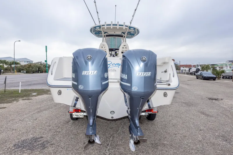 Slide: The Image of 2017 Grady-White Canyon 306 boat with twin Yamaha 300 engines, parked on a road. - 15