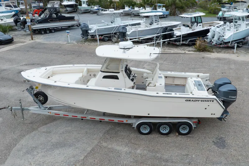 Slide: The Image of 2017 Grady-White Canyon 306 boat on trailer, parked in a marina lot. - 17