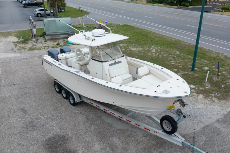 Slide: The Image of 2017 Grady-White Canyon 306 boat on trailer, parked near road. - 20
