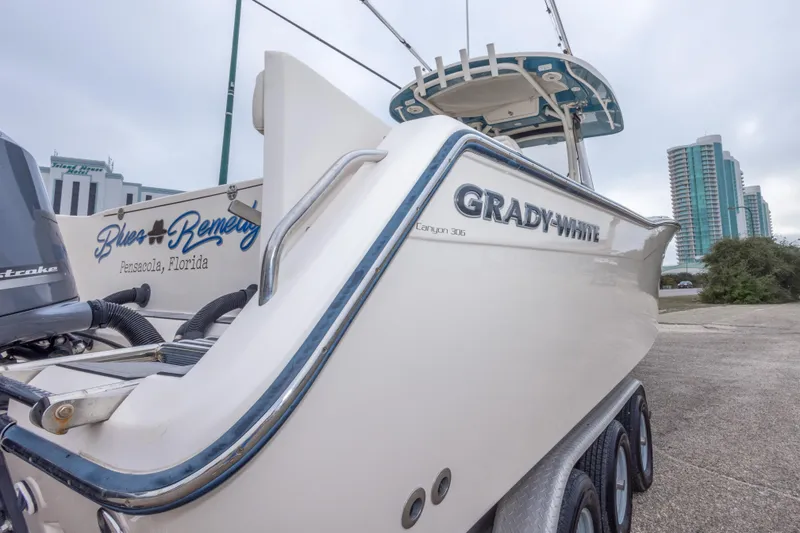 Slide: The Image of 2017 Grady-White Canyon 306 boat on trailer, Pensacola, Florida backdrop. - 22