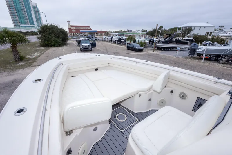 Slide: The Image of 2017 Grady-White Canyon 306 boat interior with seating, parked near marina. - 26