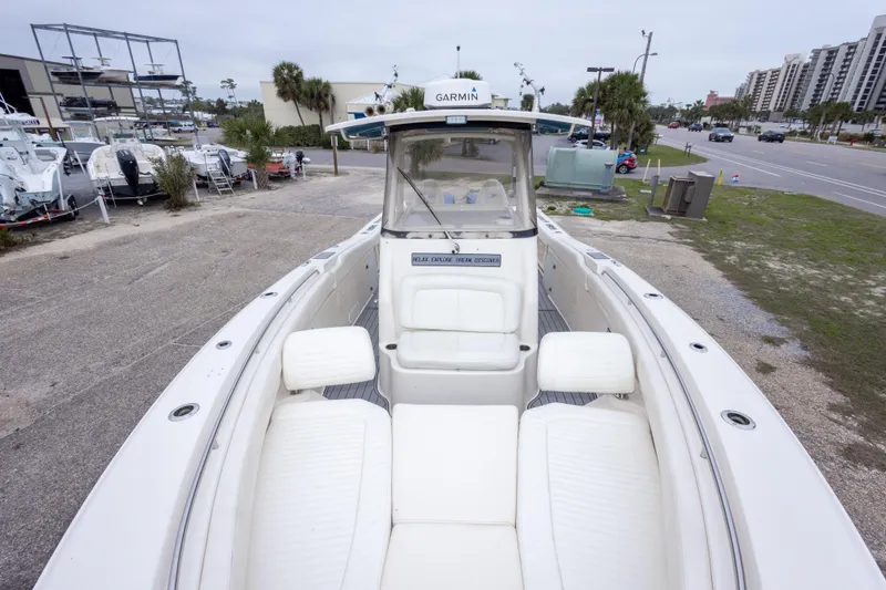 Slide: The Image of 2017 Grady-White Canyon 306 boat with white seating, parked near a marina. - 28