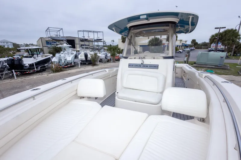 Slide: The Image of 2017 Grady-White Canyon 306 boat with spacious seating, docked at a marina. - 29