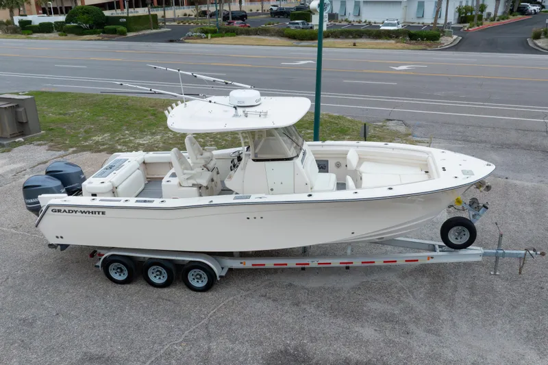 Slide: The Image of 2017 Grady-White Canyon 306 boat on trailer, parked near a road. - 3