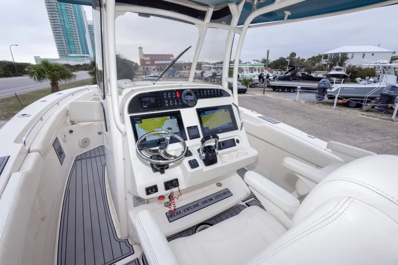 Slide: The Image of 2017 Grady-White Canyon 306 boat cockpit with advanced navigation system and steering wheel. - 31