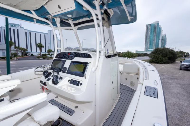 Slide: The Image of 2017 Grady-White Canyon 306 boat dashboard with cityscape background. - 33