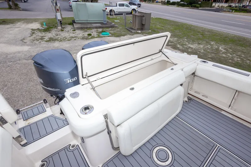 Slide: The Image of 2017 Grady-White Canyon 306 boat with open storage compartment and Yamaha 300 engine. - 38