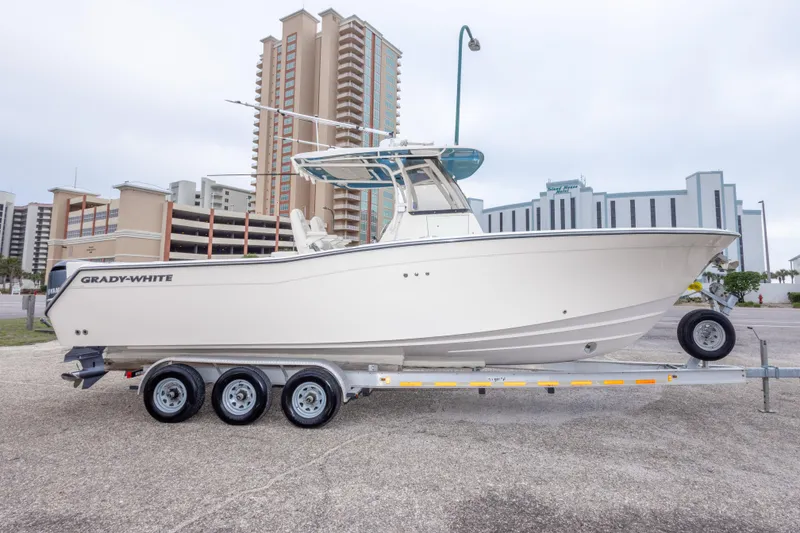 Slide: The Image of 2017 Grady-White Canyon 306 boat on trailer, urban background, side view. - 4