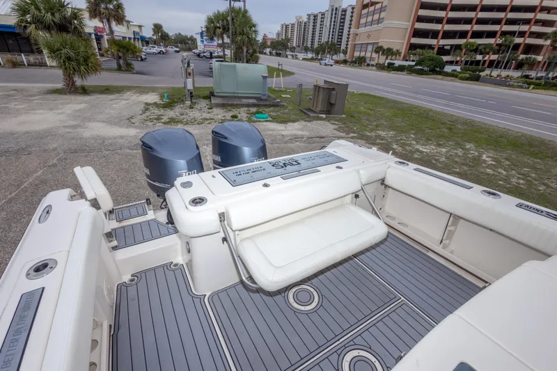 Slide: The Image of 2017 Grady-White Canyon 306 boat with twin Yamaha engines, parked near a coastal road. - 41