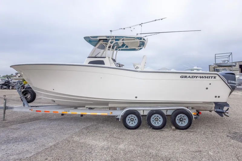Slide: The Image of 2017 Grady-White Canyon 306 boat on trailer, side view, overcast sky. - 5