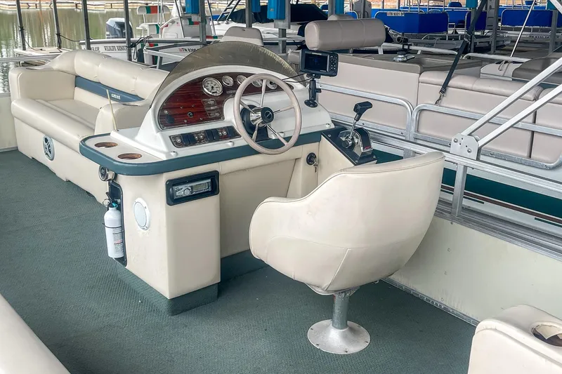 Slide: The Image of 2000 Crest 25' Pontoon boat interior with steering console and seating. - 13