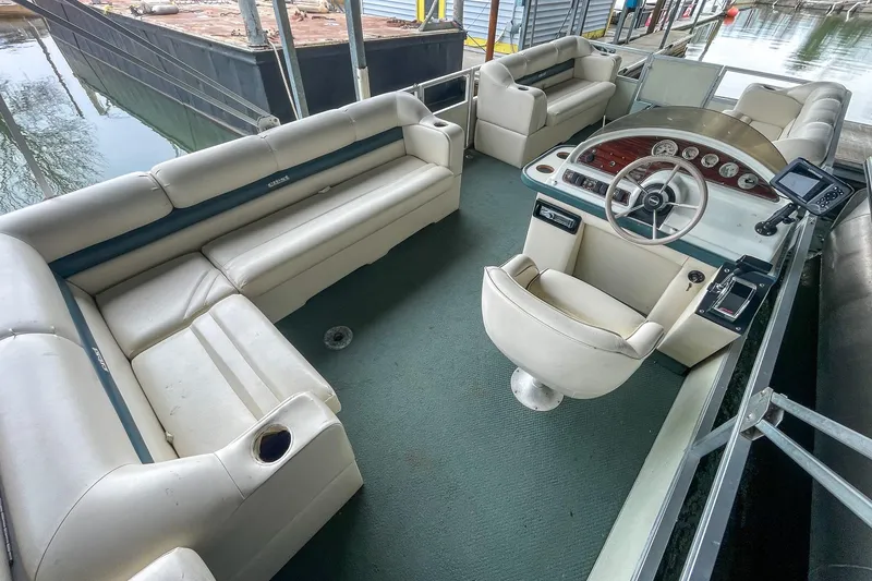Slide: The Image of 2000 Crest 25' Pontoon boat interior with spacious seating and helm. - 19