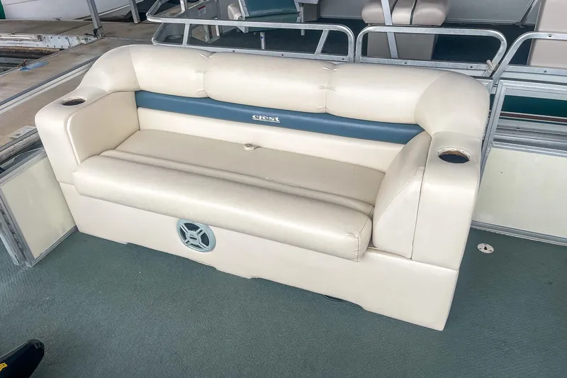 Slide: The Image of Cream-colored seating on a 2000 Crest 25' Pontoon boat with cup holders. - 21