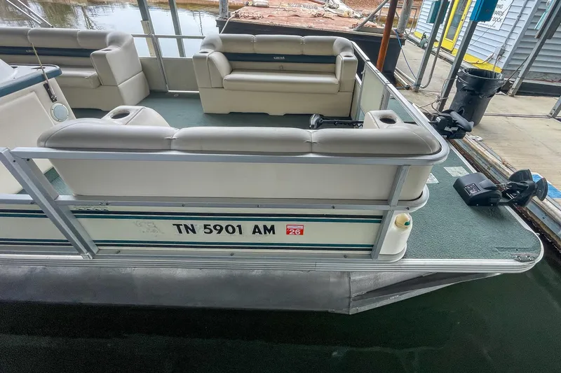 Slide: The Image of 2000 Crest 25' Pontoon boat docked, featuring spacious seating and registration number TN 5901 AM. - 23