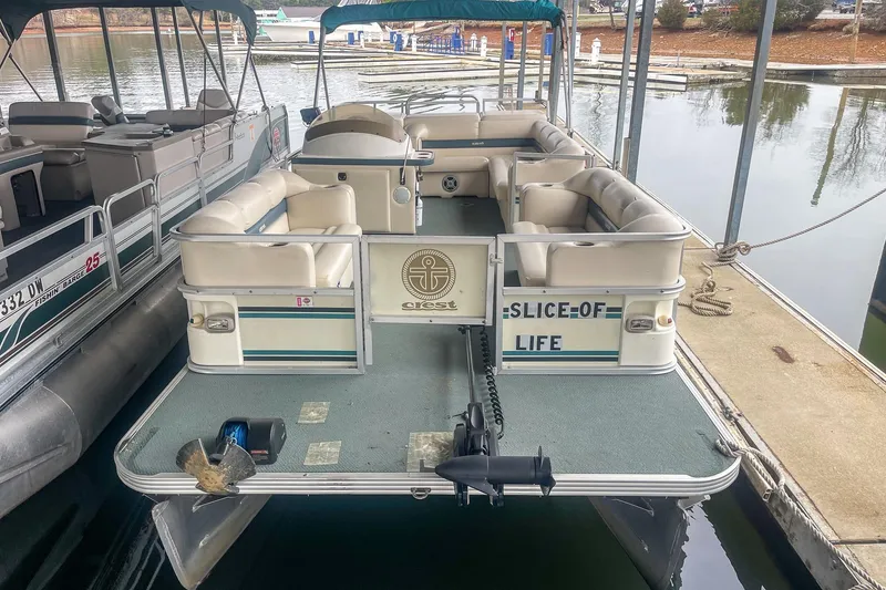 Slide: The Image of 2000 Crest 25' Pontoon boat docked, featuring spacious seating and "Slice of Life" signage. - 5